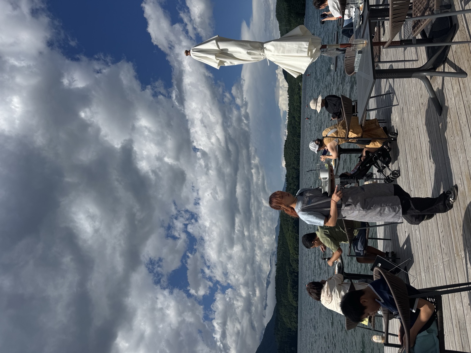 A lakeside terrace in the Alps under big open sky.
